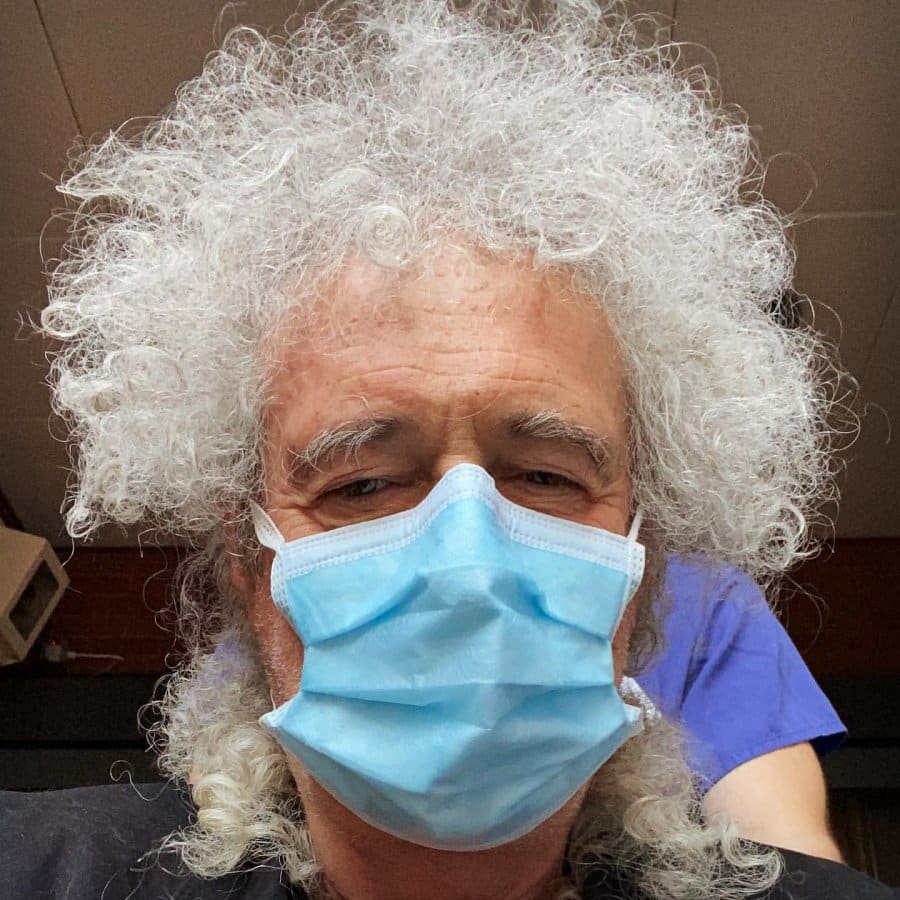 Queen guitarist Brian May in hospital with mask