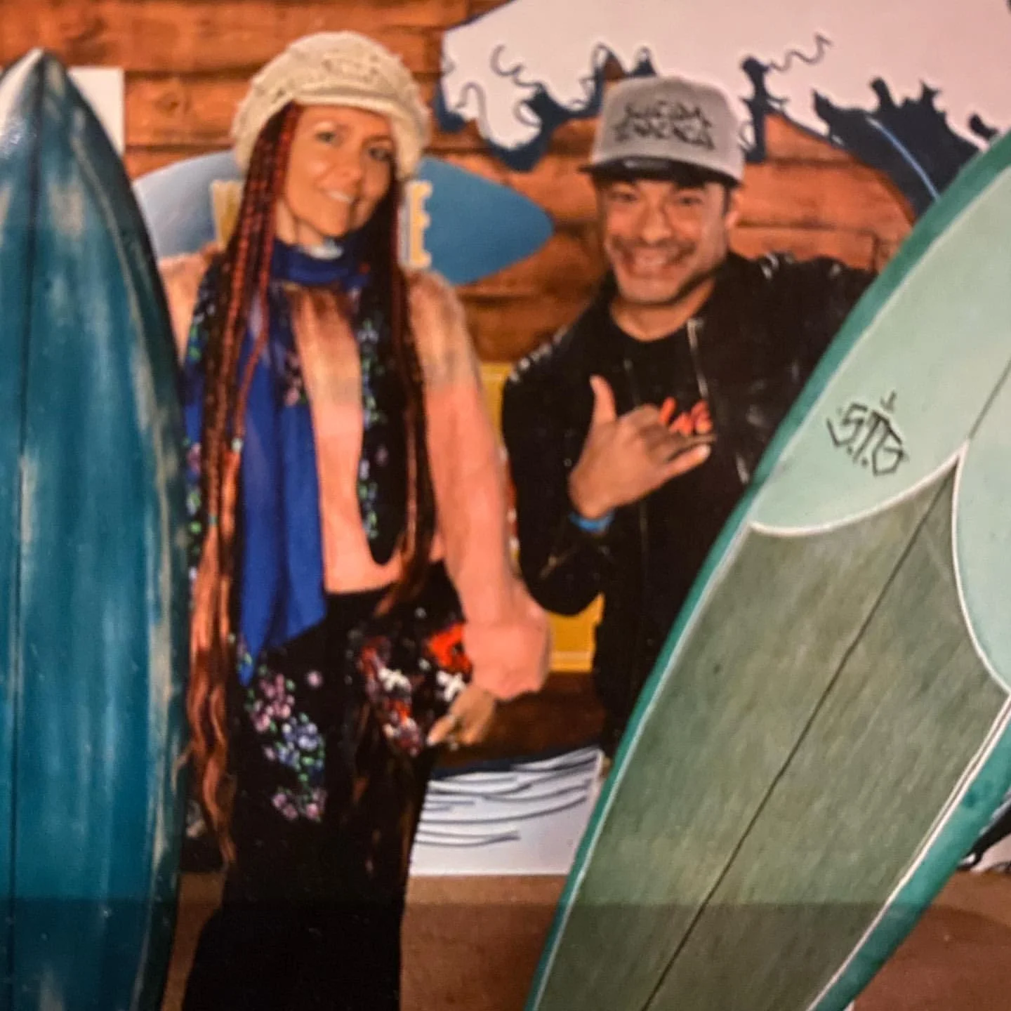 Robert Trujillo and Chloe Trujillo were posing in front of their surfboards.
