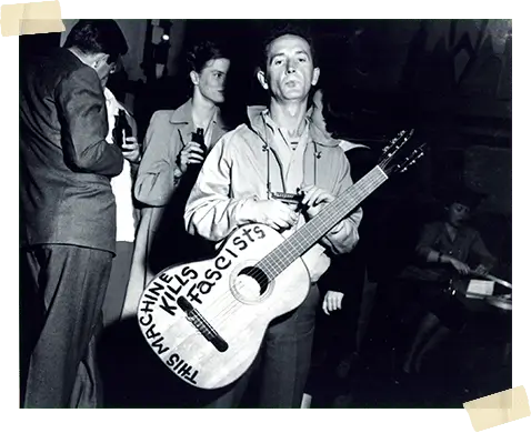 Woody-Guthrie-With-Guitar